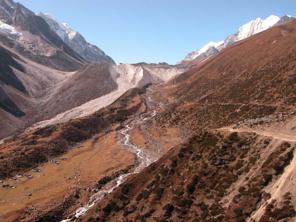 Manaslu 08 09 Larkya Phedi and Larkya LA Up ahead just below the moraine are a little village of tents called Larkya Phedi (4480m), with Larkya La (5213m) above and Larkya Peak (6010m) to the left on the pass.